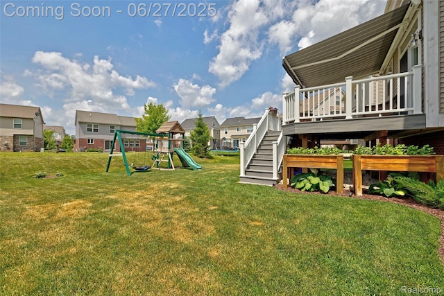 28545 Cottage Ln, New Hudson, MI 48165 - view of grassy yard featuring a playground, a residential view, a deck, and stairs