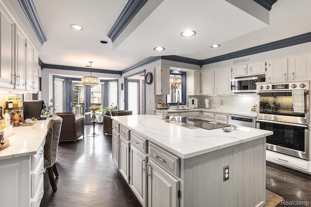 50530 Hunters Creek Trl, Shelby Twp, MI 48317 - kitchen with appliances with stainless steel finishes, crown molding, white cabinetry, a center island, and recessed lighting