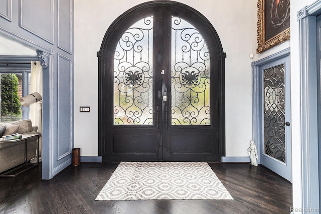 50530 Hunters Creek Trl, Shelby Twp, MI 48317 - entryway featuring french doors, dark wood-type flooring, and arched walkways