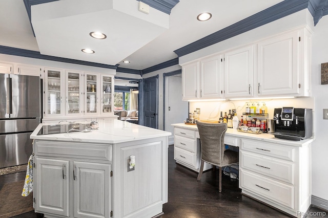 50530 Hunters Creek Trl, Shelby Twp, MI 48317 - kitchen with freestanding refrigerator, a center island, white cabinets, built in study area, and glass insert cabinets
