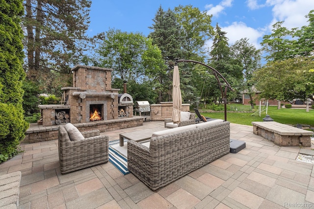 50530 Hunters Creek Trl, Shelby Twp, MI 48317 - view of patio / terrace with an outdoor living space with a fireplace