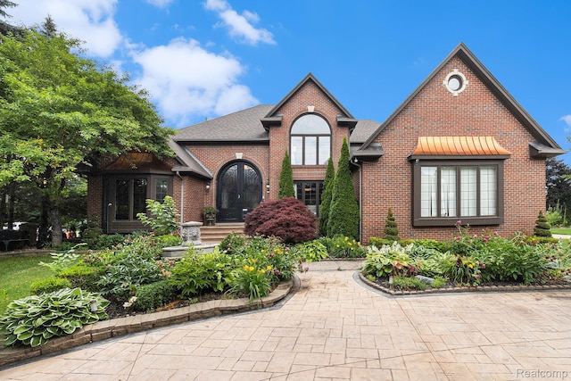 50530 Hunters Creek Trl, Shelby Twp, MI 48317 - tudor house featuring brick siding