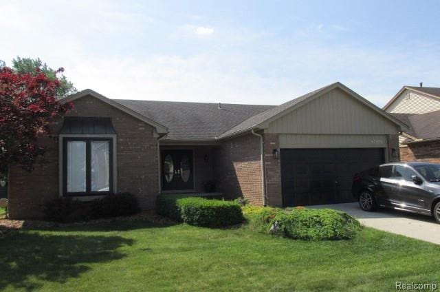 43870 Boulder Dr, Clinton Township, MI 48038 - single story home featuring brick siding, an attached garage, a front lawn, and concrete driveway