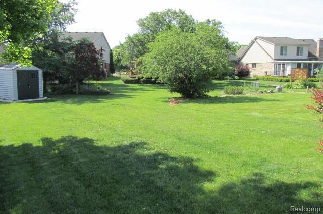 43870 Boulder Dr, Clinton Township, MI 48038 - view of grassy yard with a storage unit