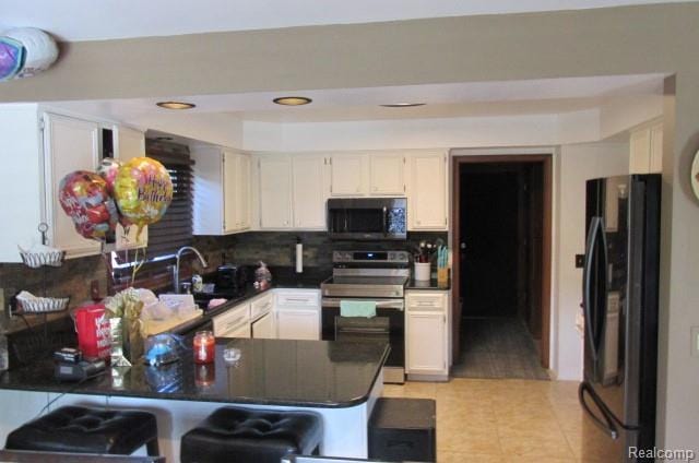 43870 Boulder Dr, Clinton Township, MI 48038 - kitchen with freestanding refrigerator, stainless steel electric range oven, a peninsula, decorative backsplash, and light tile patterned floors