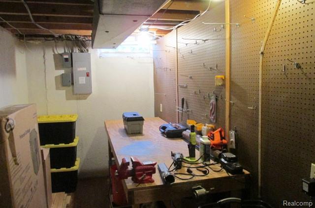 43870 Boulder Dr, Clinton Township, MI 48038 - unfinished basement with electric panel and a workshop area