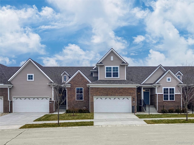 2270 Chase Dr Unit 112, Howell, MI 48855 - view of front facade with a garage, driveway, brick siding, and roof with shingles