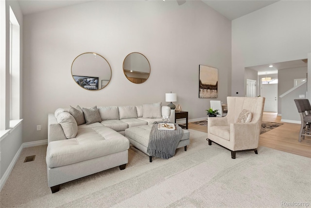 2270 Chase Dr Unit 112, Howell, MI 48855 - carpeted living room with a towering ceiling and baseboards