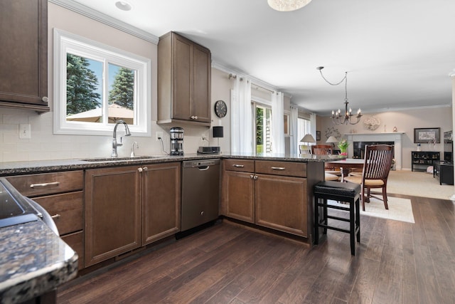 7662 Hidden Ponds Blvd, Brighton, MI 48114 - kitchen featuring dishwasher, open floor plan, a chandelier, a peninsula, and dark wood-style flooring