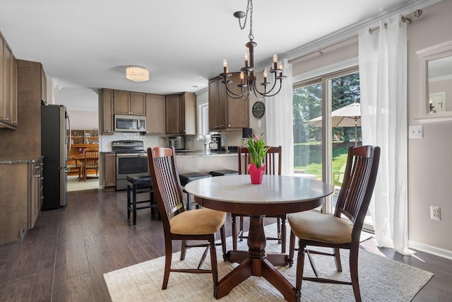 7662 Hidden Ponds Blvd, Brighton, MI 48114 - dining room featuring dark wood-type flooring and a chandelier