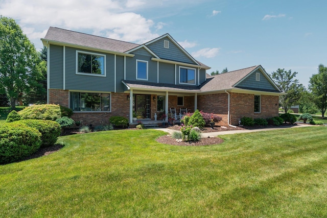 7662 Hidden Ponds Blvd, Brighton, MI 48114 - view of front of property with a porch, brick siding, and a front lawn