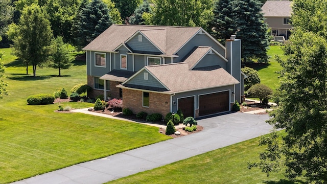7662 Hidden Ponds Blvd, Brighton, MI 48114 - craftsman inspired home with an attached garage, a chimney, driveway, brick siding, and a front lawn