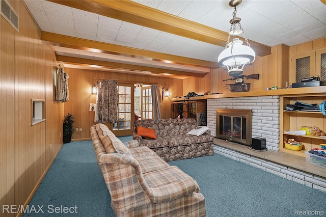 6088 Sierra Pass, Flint, MI 48532 - living area featuring carpet floors, wooden walls, a brick fireplace, and beamed ceiling