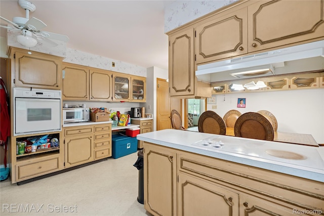 6088 Sierra Pass, Flint, MI 48532 - kitchen with white appliances, light countertops, ceiling fan, and glass insert cabinets