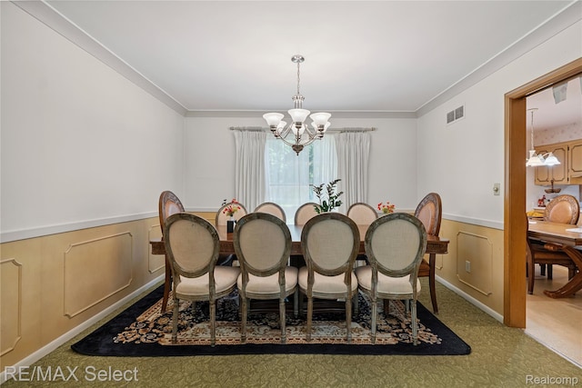 6088 Sierra Pass, Flint, MI 48532 - dining space with a chandelier, crown molding, a wainscoted wall, and carpet