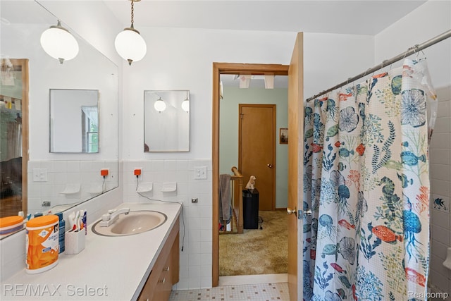 6088 Sierra Pass, Flint, MI 48532 - bathroom featuring vanity, tile walls, a shower with shower curtain, tile patterned floors, and wainscoting