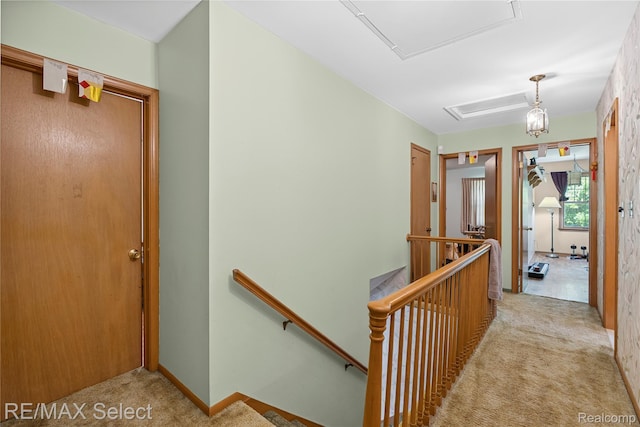 6088 Sierra Pass, Flint, MI 48532 - hall with an upstairs landing, light colored carpet, and attic access