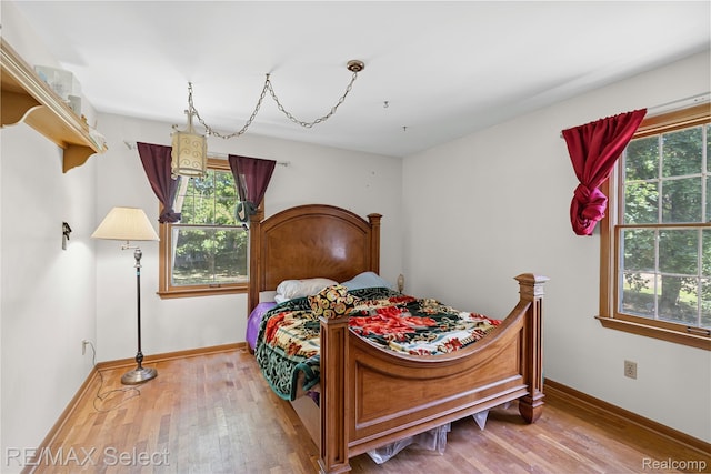 6088 Sierra Pass, Flint, MI 48532 - bedroom with multiple windows and wood finished floors