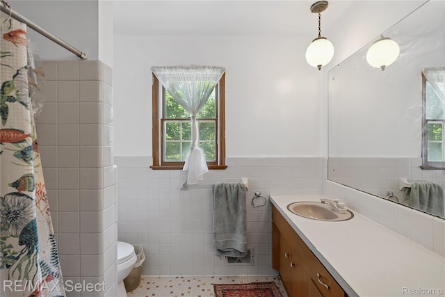 6088 Sierra Pass, Flint, MI 48532 - bathroom with tile walls, healthy amount of natural light, vanity, a wainscoted wall, and a shower with curtain