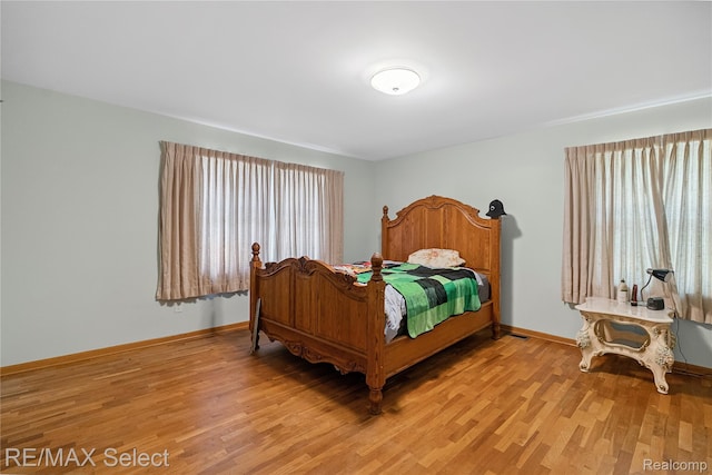 6088 Sierra Pass, Flint, MI 48532 - bedroom featuring light wood-style flooring and multiple windows