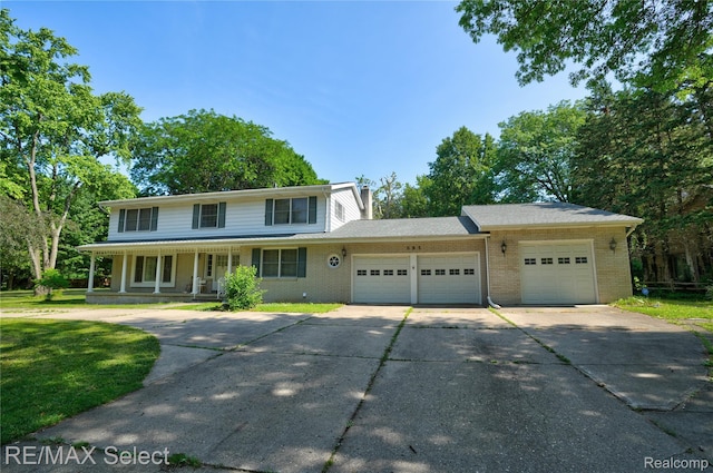 6088 Sierra Pass, Flint, MI 48532 - view of front of property featuring an attached garage, brick siding, concrete driveway, and a porch