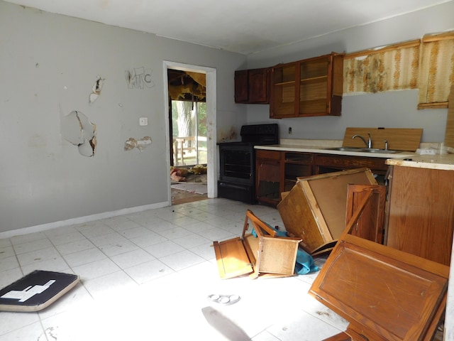 2504 Dexter Ave, Kalamazoo, MI 49004 - kitchen with black electric range, light countertops, and light flooring