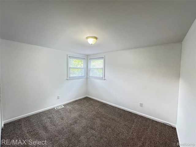 2017 Noble Ave, Flushing, MI 48532 - spare room with dark carpet and baseboards