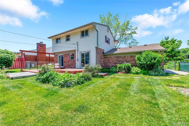 607 Ashburnham St, Auburn Hills, MI 48326 - back of property with brick siding and a wooden deck