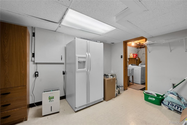 607 Ashburnham St, Auburn Hills, MI 48326 - finished below grade area featuring white refrigerator with ice dispenser, washer / clothes dryer, a paneled ceiling, and light flooring