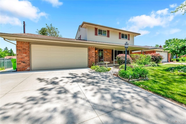 607 Ashburnham St, Auburn Hills, MI 48326 - traditional-style home with brick siding, an attached garage, driveway, and a porch