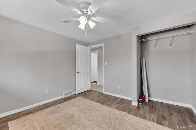 607 Ashburnham St, Auburn Hills, MI 48326 - unfurnished bedroom featuring wood finished floors, a closet, and a ceiling fan