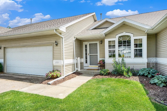 1721 Quail Run Dr, Kalamazoo, MI 49009 - view of front facade with a shingled roof, a garage, driveway, and a front lawn