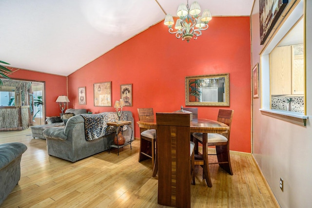 1721 Quail Run Dr, Kalamazoo, MI 49009 - dining space featuring wood finished floors, a chandelier, and high vaulted ceiling