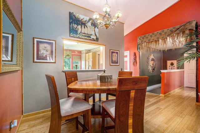 1721 Quail Run Dr, Kalamazoo, MI 49009 - dining space featuring vaulted ceiling, wood finished floors, and a chandelier