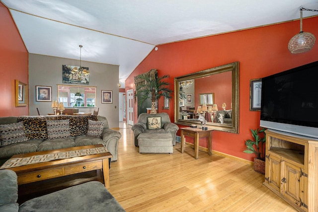 1721 Quail Run Dr, Kalamazoo, MI 49009 - living area featuring wood finished floors, vaulted ceiling, and a chandelier