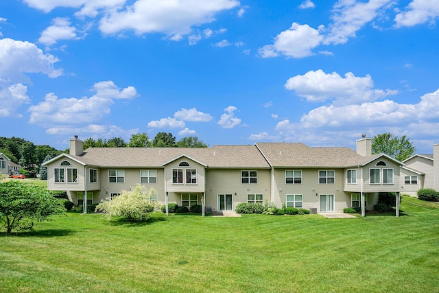1721 Quail Run Dr, Kalamazoo, MI 49009 - rear view of property featuring a lawn and a chimney