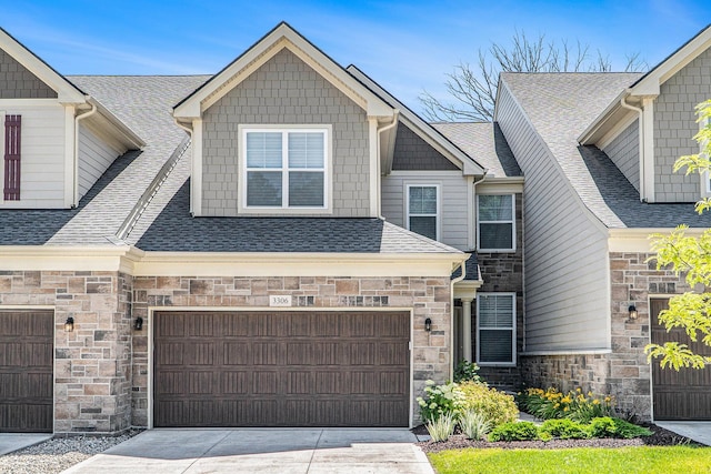 3306 Sunton Rd, Ann Arbor, MI 48105 - view of front of property with stone siding, roof with shingles, driveway, and an attached garage