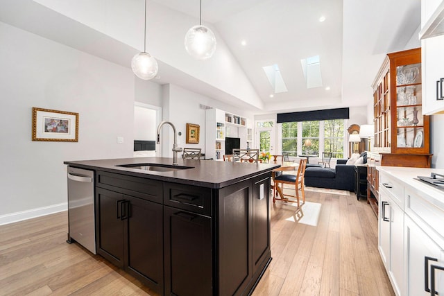 3306 Sunton Rd, Ann Arbor, MI 48105 - kitchen featuring a skylight, dishwasher, open floor plan, high vaulted ceiling, and dark countertops
