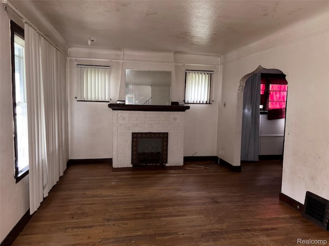 14892 Hubbell St, Detroit, MI 48227 - unfurnished living room with wood finished floors, healthy amount of natural light, and a fireplace