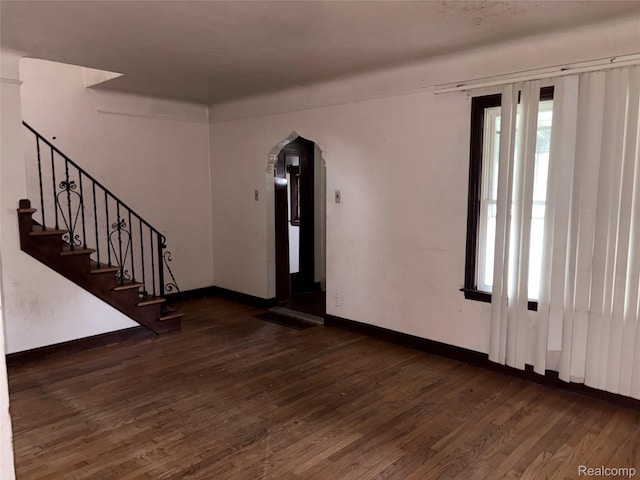 14892 Hubbell St, Detroit, MI 48227 - spare room with arched walkways, wood finished floors, healthy amount of natural light, and stairway