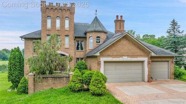 9000 Ferry Rd, Grosse Ile, MI 48138 - view of front of house with brick siding, driveway, roof with shingles, and a chimney