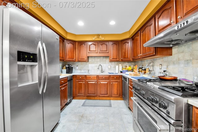 9000 Ferry Rd, Grosse Ile, MI 48138 - kitchen with stainless steel appliances, ventilation hood, tasteful backsplash, light countertops, and recessed lighting
