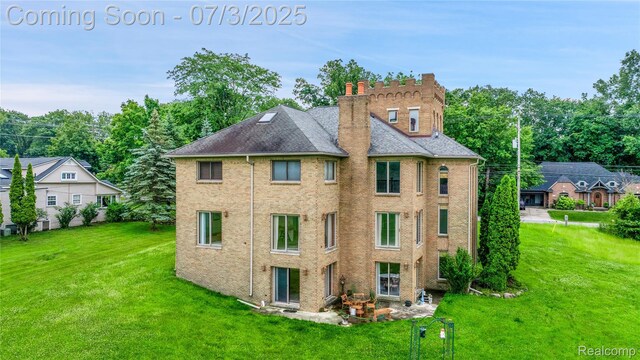 9000 Ferry Rd, Grosse Ile, MI 48138 - rear view of property featuring a lawn and a chimney