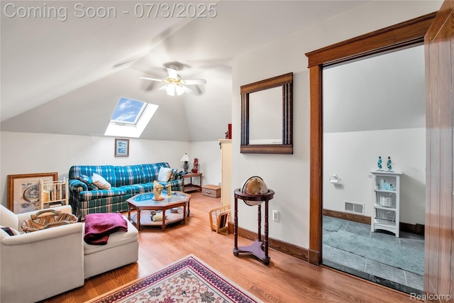 9000 Ferry Rd, Grosse Ile, MI 48138 - living room featuring ceiling fan, a skylight, wood finished floors, and vaulted ceiling