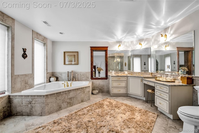 9000 Ferry Rd, Grosse Ile, MI 48138 - full bath with vanity, a bath, and marble look tiles