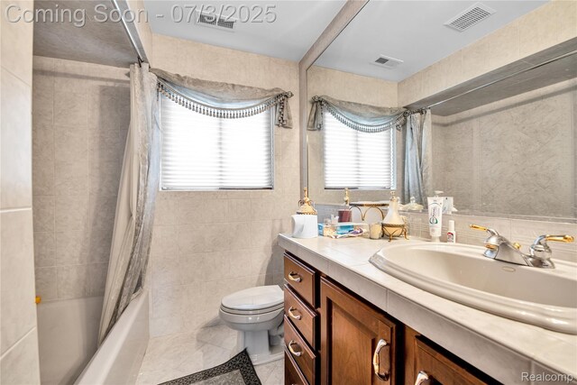9000 Ferry Rd, Grosse Ile, MI 48138 - bathroom with tile walls, shower / bath combo with shower curtain, and vanity