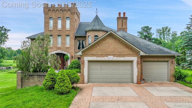 9000 Ferry Rd, Grosse Ile, MI 48138 - view of front facade with driveway, brick siding, an attached garage, and roof with shingles