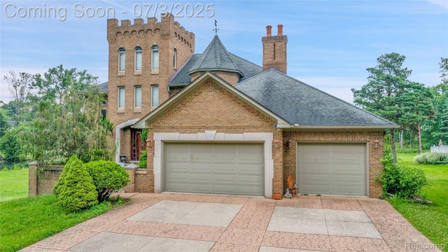 9000 Ferry Rd, Grosse Ile, MI 48138 - view of front facade with roof with shingles, brick siding, driveway, a chimney, and an attached garage