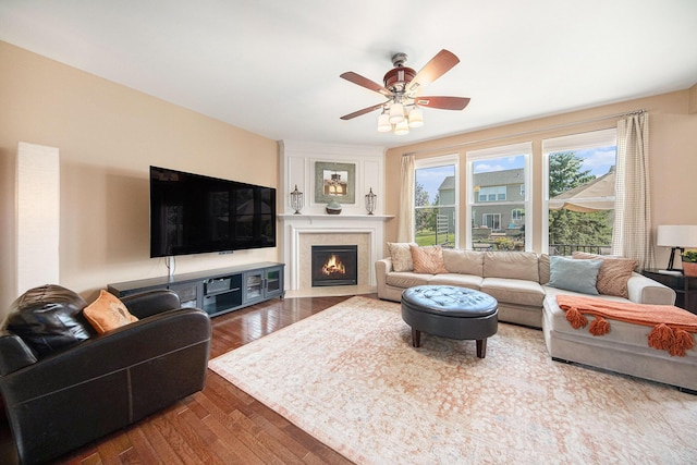 440 Shiloh Dr, Chelsea, MI 48118 - living area featuring wood finished floors, a ceiling fan, and a fireplace