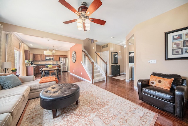 440 Shiloh Dr, Chelsea, MI 48118 - living room with dark wood finished floors, stairway, and a ceiling fan